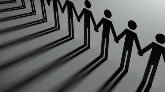 Paper stick men holding hands