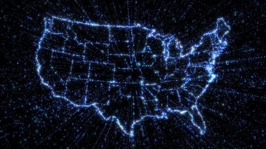 Outline map of US states in glowing blue with exploding streams of binary data illustrating communication, internet and technology