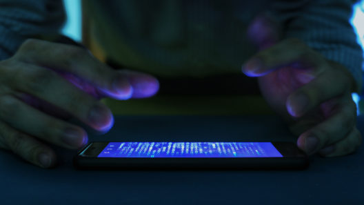 smartphone with code binary on screen.