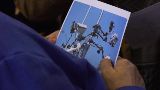 Person holding image of surveillance camaras