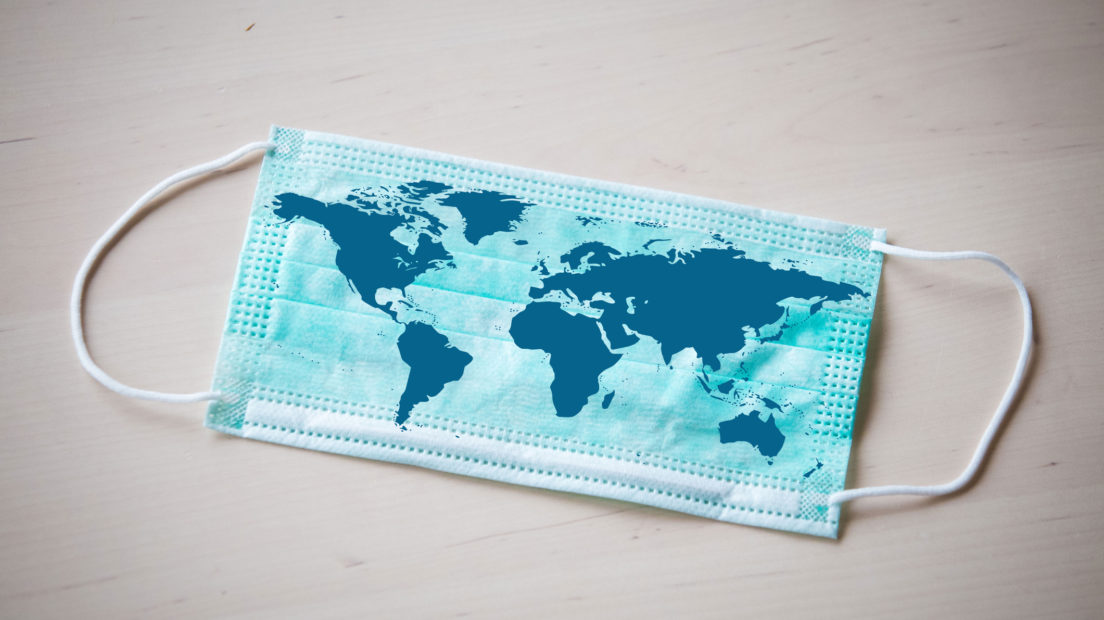 A medical face mask on which a map of the world is printed.