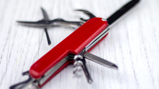 Red penknife on a white table