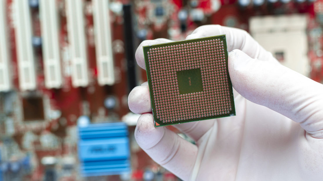 close up the scientist hand holding a cpu processor chip, working in the laboratory