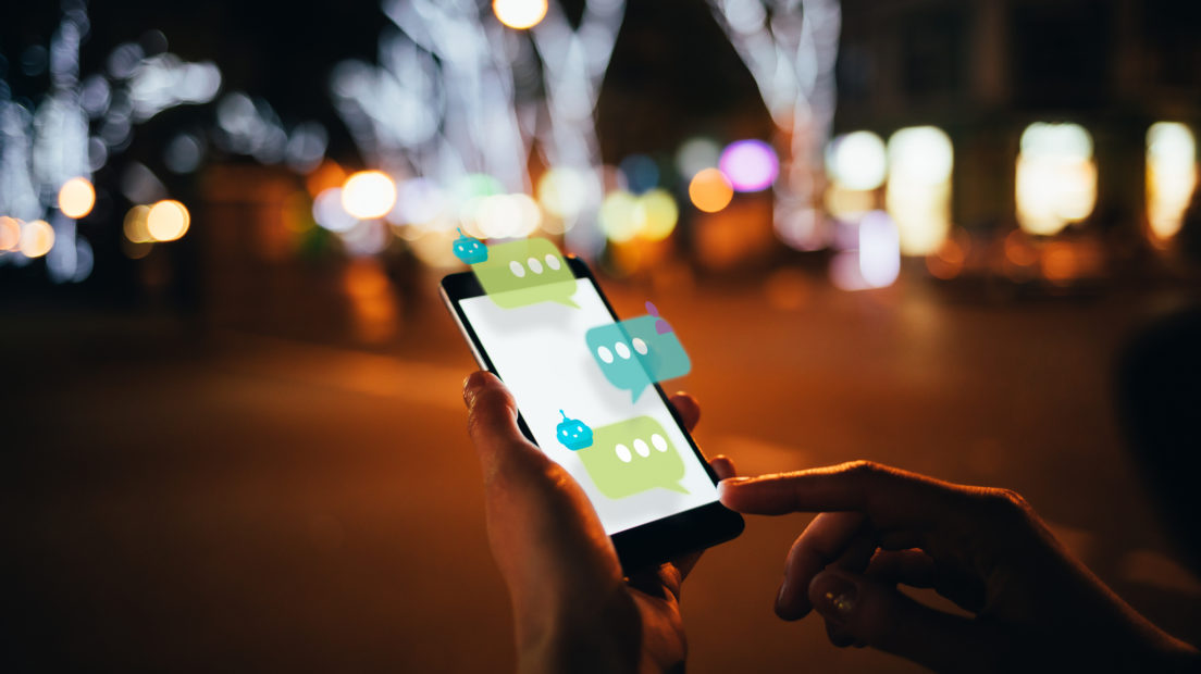 User dialogue with AI chat bot on futuristic smartphone interface, while walking along the city street, close-up