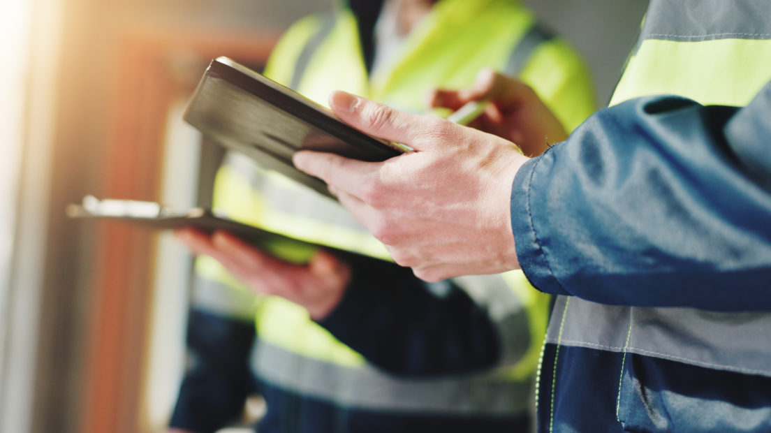 Hands, construction worker and tablet for meeting, review and team with safety report at site. People, engineer and architect with touchscreen, checklist and application for survey at property